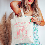 Last Toast On The Coast Beach Bachelorette Party Tote Bag<br><div class="desc">Elevate your beach bachelorette experience with our Last Toast On The Coast Beach Bachelorette Party Tote Bag – the perfect combination of functionality and style for your coastal celebration. This tote bag goes beyond ordinary accessories; it's a symbol of personalized luxury, making it an ideal addition to your beach bachelorette...</div>