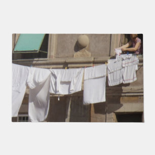 Laundry on clothesline from balcony Door Mat