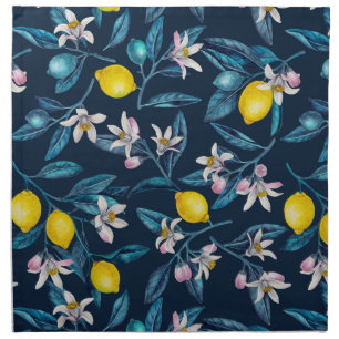 Lemon branches with blossoms and fruit on blue cloth napkin