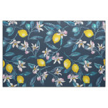Lemon branches with blossoms and fruit on blue fabric