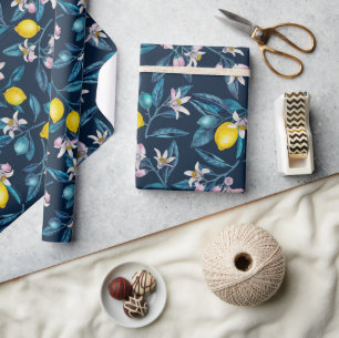 Lemon branches with blossoms and fruit on blue wrapping paper