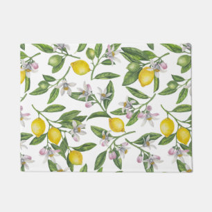 Lemon branches with blossoms and fruit on white doormat