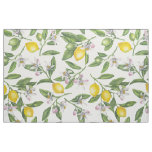 Lemon branches with blossoms and fruit on white fabric