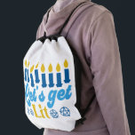 Let's Get Lit! Backpack<br><div class="desc">This cheeky Hanukkah pattern is an eye-catcher! It's a fun and funky way to dress up decor,  gifts,  apparel,  and household items for the occasion. Check out my store for more pattern items and gift ideas,  or combine items to create an interesting gift package!</div>