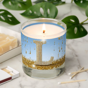 Letter L on Gold Glitter Background With Sparkling Scented Candle