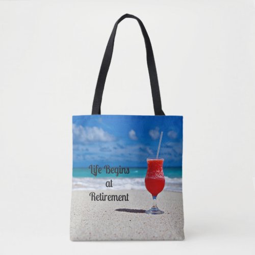 Life Begins at Retirement__Frosty Drink on Beach  Tote Bag