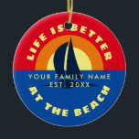 Life is better at the beach tropical Christmas Ceramic Ornament<br><div class="desc">Life is better at the lake tropical Christmas tree Ornament (Ceramic ). Custom x-mas tree ornament with orange ocean sunset view and sail boat silhouette. Cute tropical Holiday present with funny quote. Make your own decoration. Includes gold glitter string for hanging it up. Add your own photo or text on...</div>