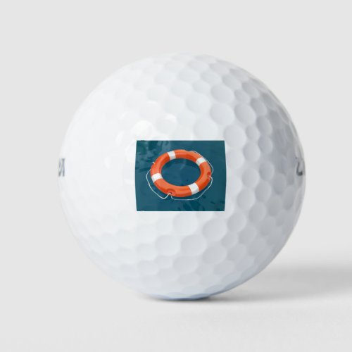 Lifebuoy ring floating on water golf balls
