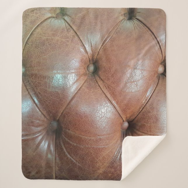 Light on brown leather sofa surface, textureabstra sherpa blanket (Front)
