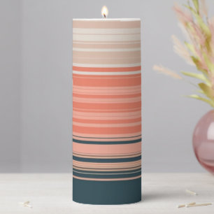 Light peach, coral, and orange striped pattern pillar candle