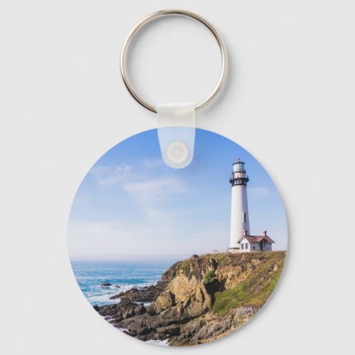 Lighthouse on hill blue sky white house ocean keychain