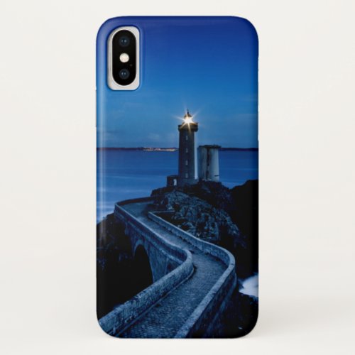 Lighthouse on wall in ocean at night iPhone x case