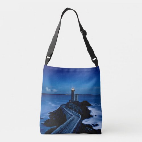 Lighthouse on wall in ocean at night crossbody bag