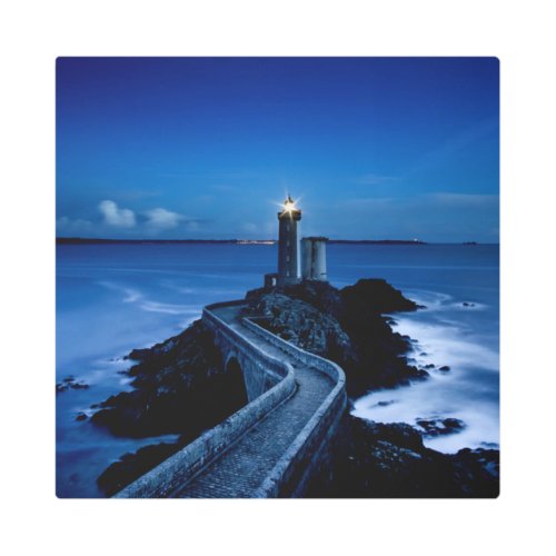 Lighthouse on wall in ocean at night metal print