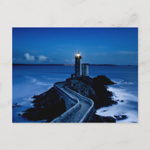 Lighthouse on wall in ocean at night postcard
