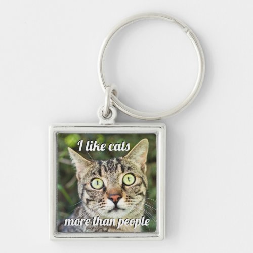Like cats more than people green_eyed cat close_up keychain