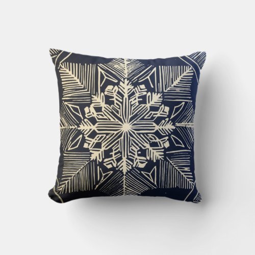 linocut design of a snowflake throw pillow