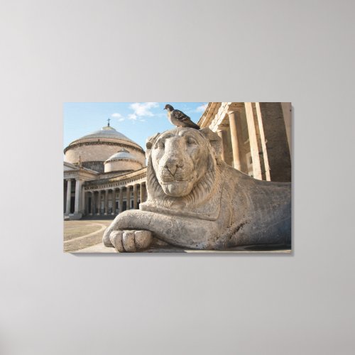 Lion statue in front of historic church canvas print
