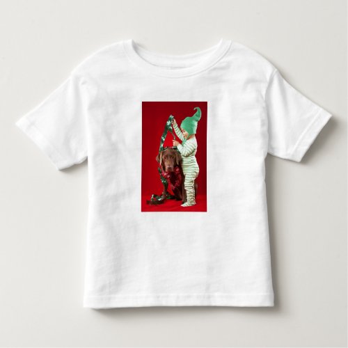 Little boy decorating a dog toddler t_shirt