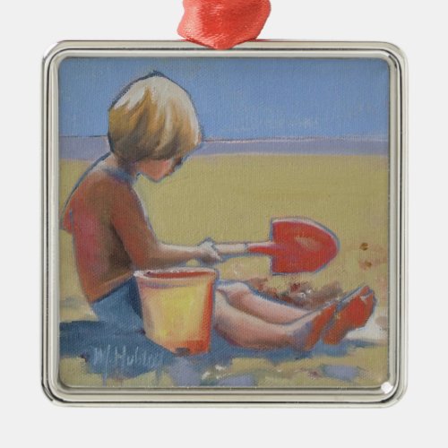 Little boy playing in the sand with a shovel metal ornament