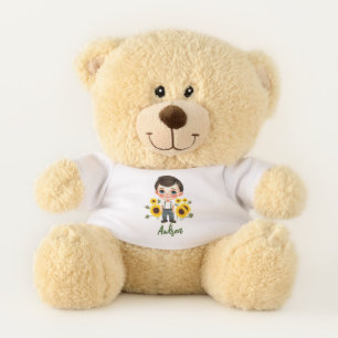 Little boy with sunflowers teddy bear