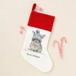 Little Bunny's First Christmas, custom Christmas Stocking<br><div class="desc">Make your little one's first Christmas morning truly magical with our "Little Bunny's First Christmas" custom Christmas stocking! This enchanting stocking features the sweetest little bunny wearing a cozy blue winter hat, nestled in a whimsical snowy scene with delicate snowflakes. It's the perfect personalized touch to welcome Santa's treats and...</div>