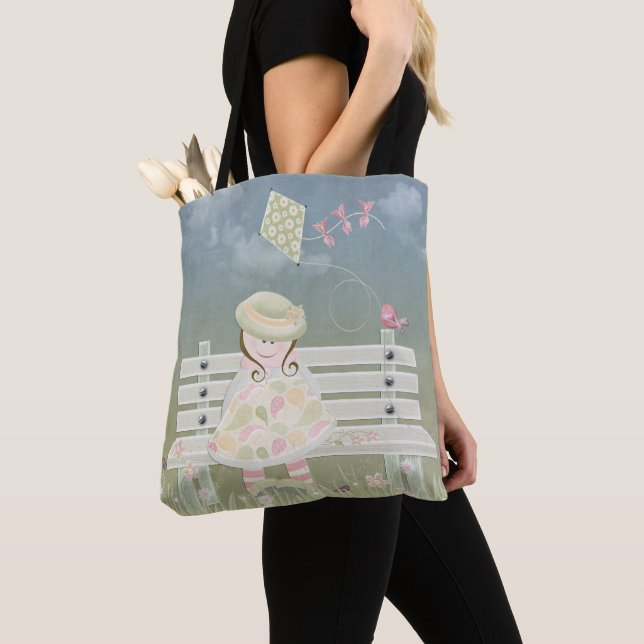 little girl on park bench with kite and bird tote bag (Close Up)