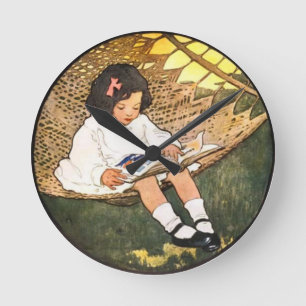 Little Girl reading in a hammock Round Clock