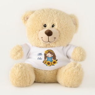 Little girl with sunflowers teddy bear