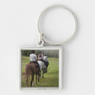 Little girls riding horses keychain