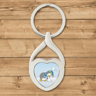 Little penguin getting a snow ball keychain