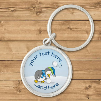 Little penguin getting a snow ball keychain