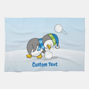 Little penguin getting a snow ball kitchen towel
