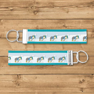 Little penguin getting a snow ball wrist keychain