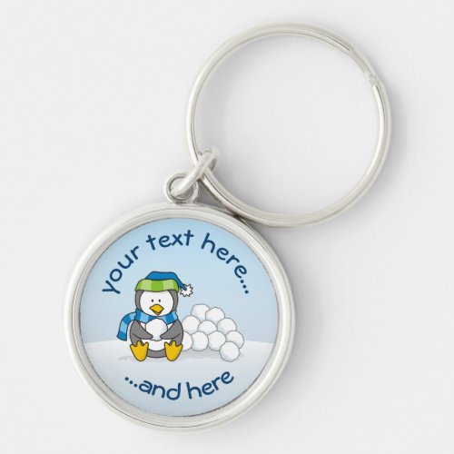 Little penguin sitting with snowballs keychain