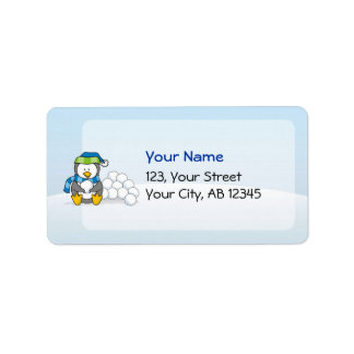 Little penguin sitting with snowballs label