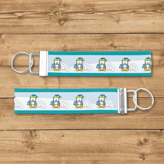 Little penguin sitting with snowballs wrist keychain