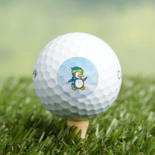 Little penguin walking on snow golf balls