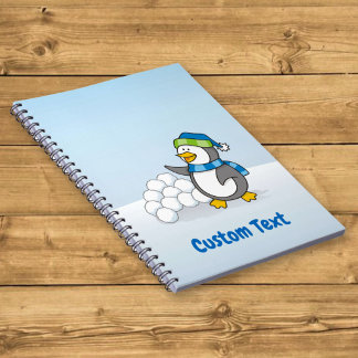 Little penguin with snow balls waving notebook