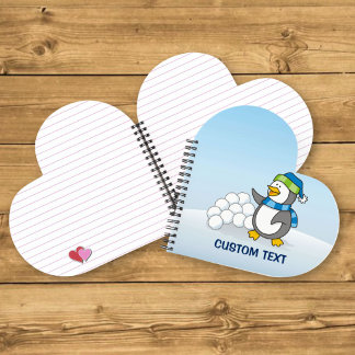 Little penguin with snow balls waving notebook