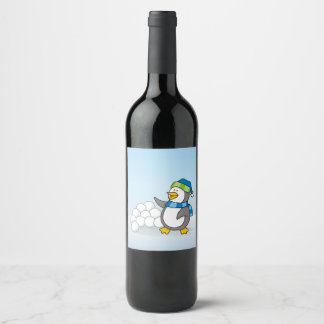 Little penguin with snow balls waving wine label
