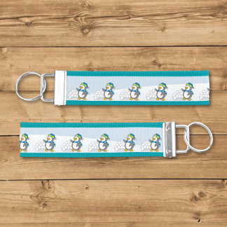 Little penguin with snow balls waving wrist keychain