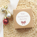 Little Red Bow | Custom Family Name Christmas Classic Round Sticker<br><div class="desc">Add a festive touch to your holiday gifts and cards with this charming round sticker! Featuring your family name in simple, modern typography and a cute watercolor red bow beneath it, this sticker is perfect for sealing envelopes, decorating gift boxes, or adding a special touch to party favors. Check out...</div>