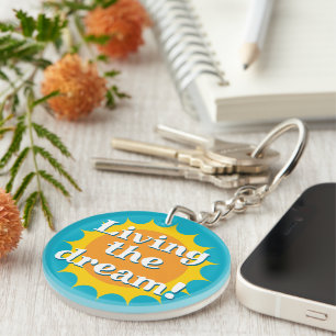 Living the dream round yellow sun rays keychain