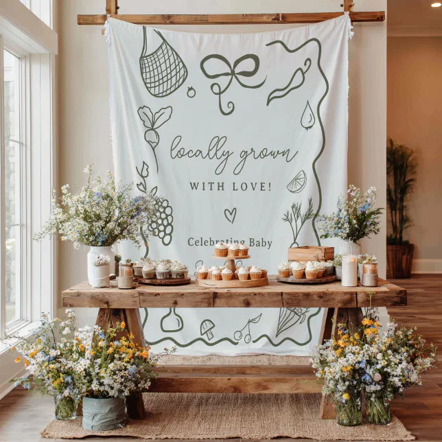 A rustic, farm-themed food setup with wildflower bouquets framing the sweet treats and a sketch-y/hand-drawn backdrop hanging behind!