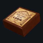 Log Cabin Personalized Faux Wood Jewelry Box<br><div class="desc">This rustic, custom cabin design has a swirled, faux wood look that gets lighter in the middle. Inside the old-fashioned cabin drawing - derived from a vintage, early 1900's advertisement - you can add your name. The word "CABIN" can also be changed to "HOME" or another short word. The design...</div>