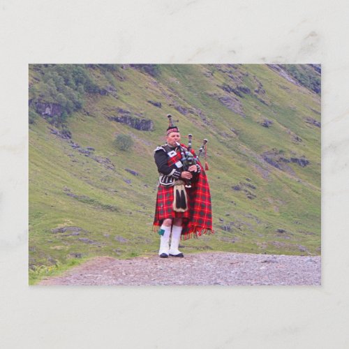 Lone Scottish bagpiper Highlands Scotland Postcard