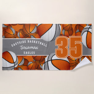 Lots of basketballs with orange gray team colors beach towel