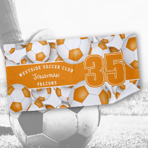 Lots of soccer balls orange white team colors beach towel