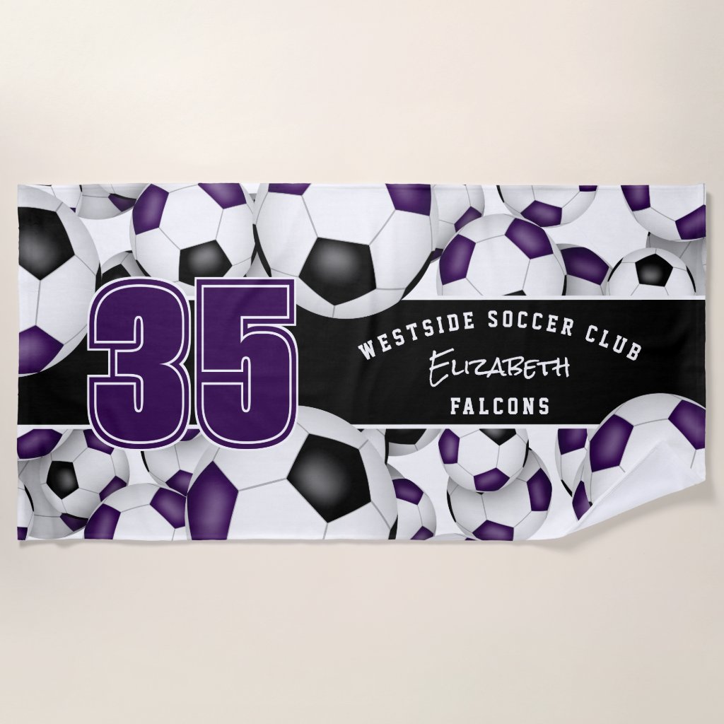 Lots of soccer balls purple black team colors beach towel